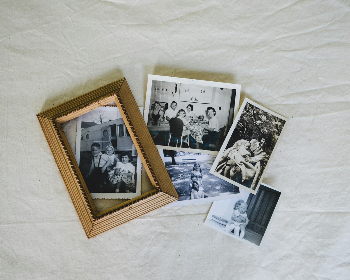 Old family photographs and frames on a table
